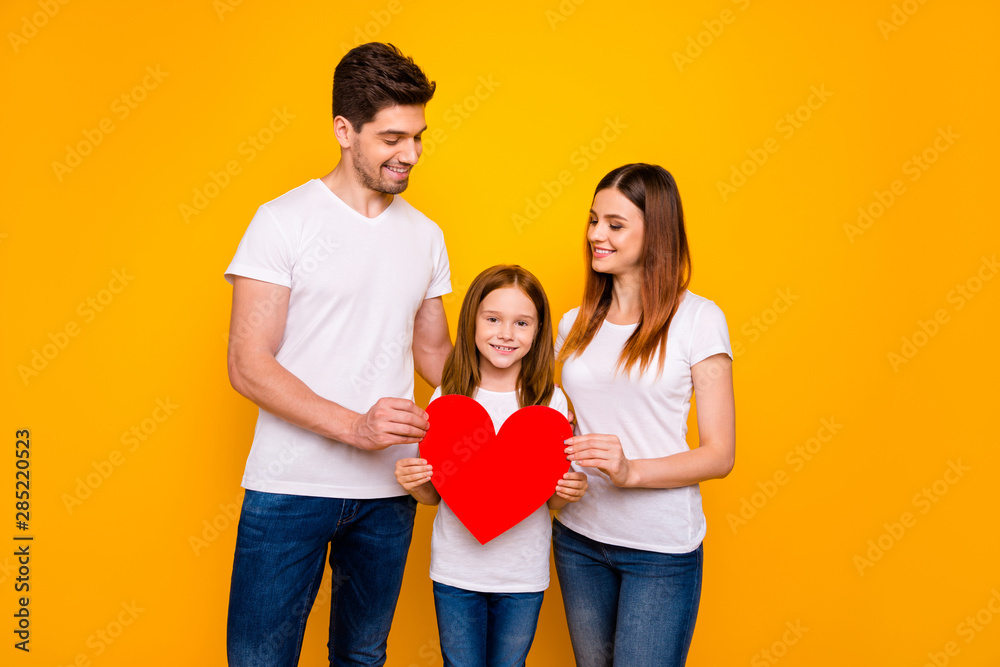 Daddy mommy and little foxy lady posing for family portrait with big paper heart wear casual clothes isolated yellow background Daddy mommy and little foxy lady posing for family portrait with big paper heart wear casual clothes isolated yellow background