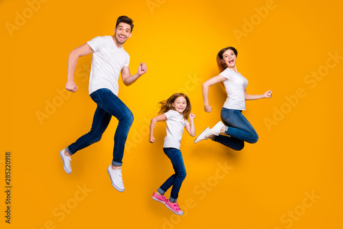 Fototapeta Naklejka Na Ścianę i Meble -  Full length body size view of three nice attractive slim fit sporty sportive lovely cheerful cheery person having fun active life activity motion isolated over bright vivid shine yellow background