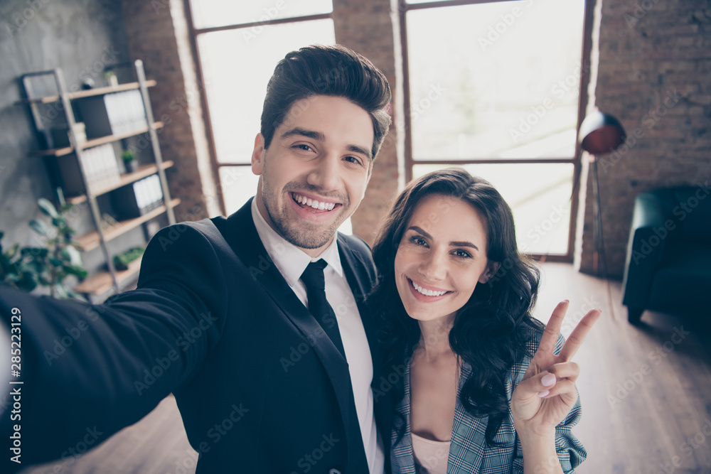 Photo of two partners making selfies in new workshop office showing v-sign dressed formal wear suits