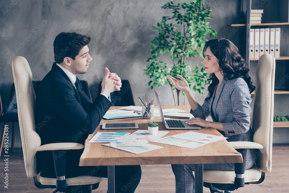 Photo of two business people lady and guy chatting about new project sitting office chairs workshop