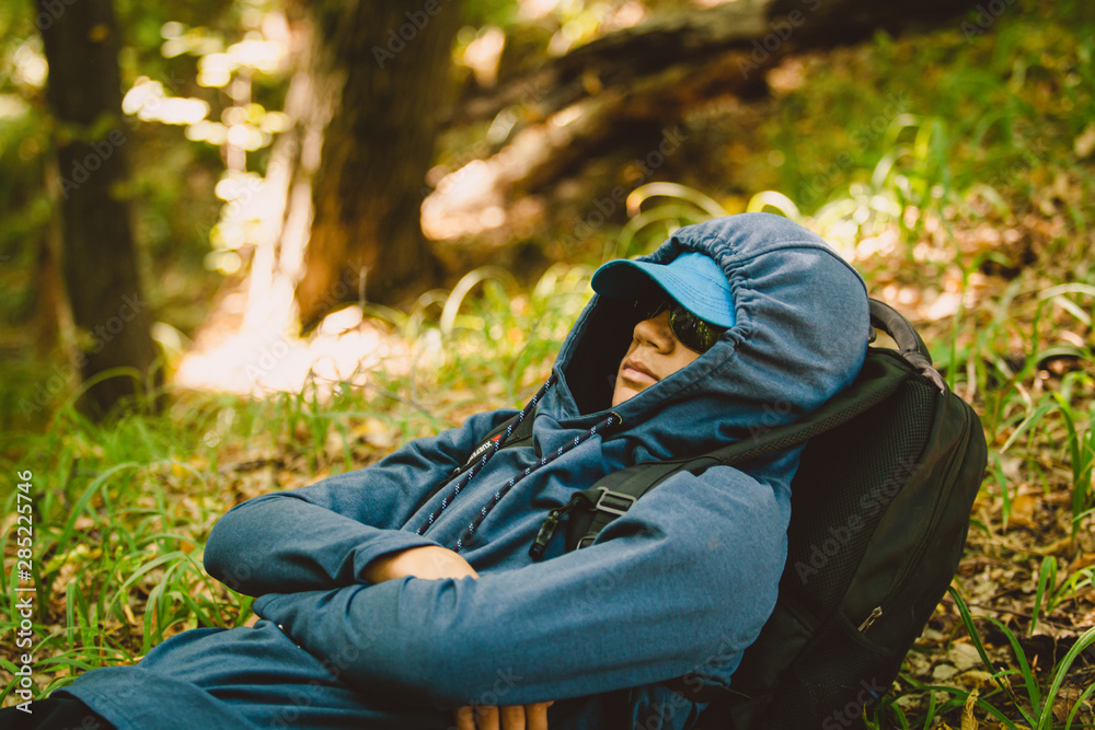 Traveler guy walks through the woods Traveler guy walks through the woods