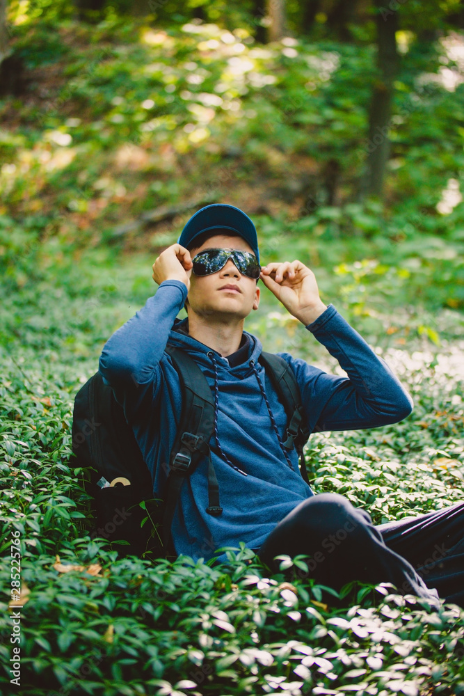 Traveler guy walks through the woods Traveler guy walks through the woods