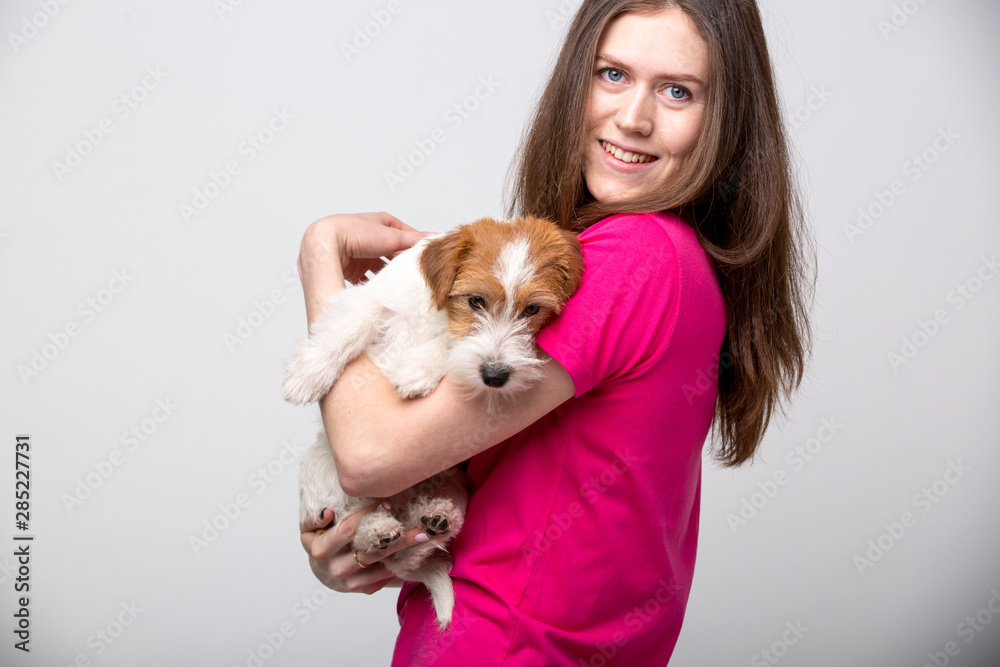 Pretty girl with terrier puppy. Studio image Pretty girl with terrier puppy. Studio image
