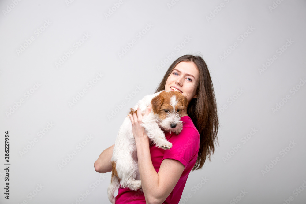 Pretty girl with terrier puppy. Studio image Pretty girl with terrier puppy. Studio image