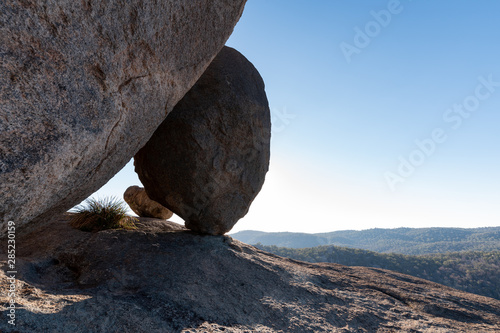 Huge boulders balance perfectly on Pyramid Rock on a clear and sunny day in Girraween NP, Queensland, Australia photo