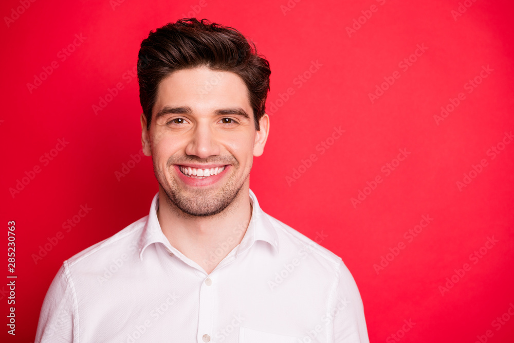 Close up photo of charming person with beaming smile wearing white shirt isolated over red background Close up photo of charming person with beaming smile wearing white shirt isolated over red background