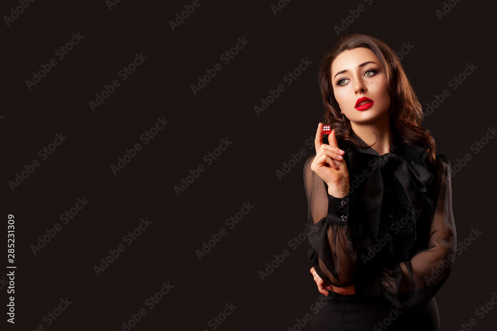casino gambling. craps or other card games lucky woman with red lips is holding a red dice with the number three in her hands. Red dice casino gambling. craps or other card games lucky woman with red lips is holding a red dice with the number three in her hands. Red dice