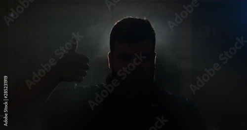 Anamorphic lens. A discreet shot of a black man puffs smoke like