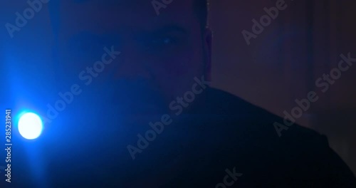 The man with a flashlight walking. anamorphic lens shot closeup, 4k