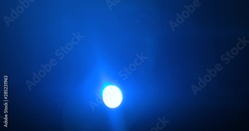 The man with a flashlight walking on the road. night time. anamorphic lens shot 4k
