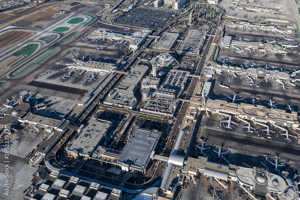 Afternoon aerial view of busy terminals and loop road at LAX airport on