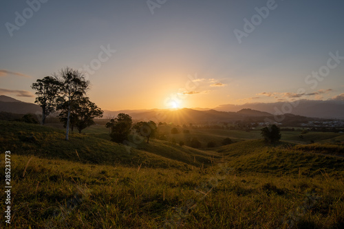 As the sun sets it casts beautiful colours and shadows across the farm fields and landscape of Murwillumbah, NSW, Australia