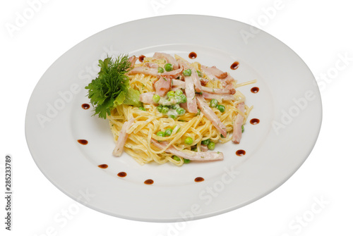 Stir-fried noodles, mixed greens in white sauce on a white isolated background
