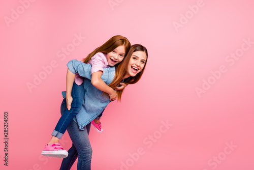 Funny foxy little lady and her mom spending weekend together wear casual clothes isolated pink background photo