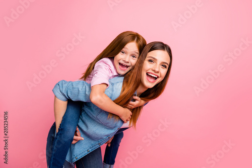 Pretty foxy little lady and her mom spending weekend together wear casual clothes isolated pink background