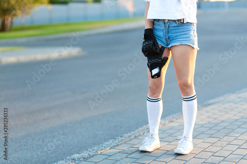Closeup girl hold special gloves for skateboard ride