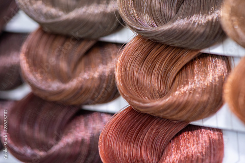 Hair color chart. Palette of dyed shiny hair samples. Catalog for selection in a beauty salon