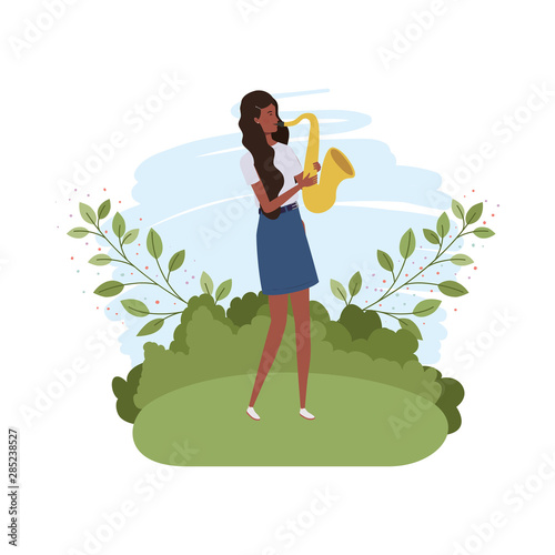 woman with saxophone and branches and leaves in the background