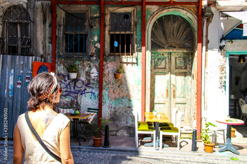 woman and colorful old buildings in Balat in Istanbul
