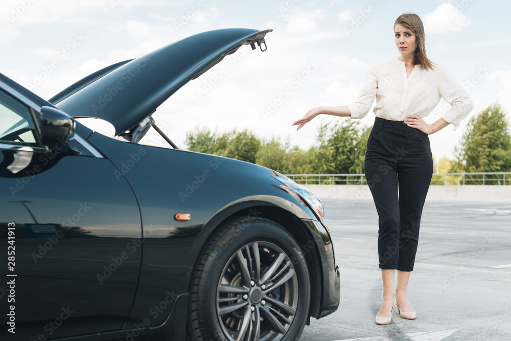 Front view of woman and black car Front view of woman and black car