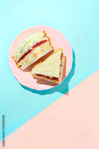 Trendy Korean sandwich inkigayo on two-color pastel background, top view, vertical orientation photo