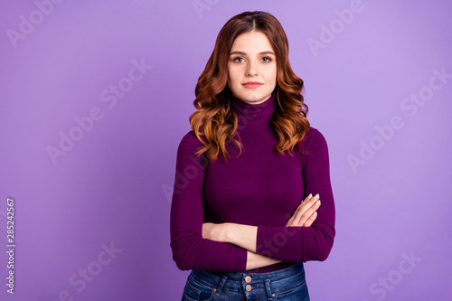 Portrait of concentrated lovely woman look listen wear denim jeans isolated over violet purple background