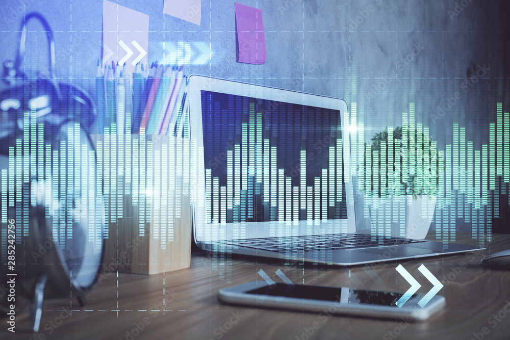 Financial chart drawing and table with computer on background. Multi exposure. Concept of international markets. Financial chart drawing and table with computer on background. Multi exposure. Concept of international markets.