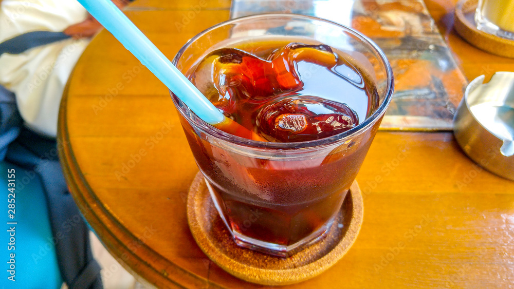 cold coffee with ice cubes and pipette in a coffee shop cold coffee with ice cubes and pipette in a coffee shop