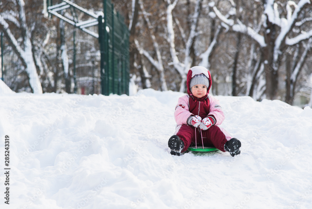 kid slides down a hill on a sled kid slides down a hill on a sled
