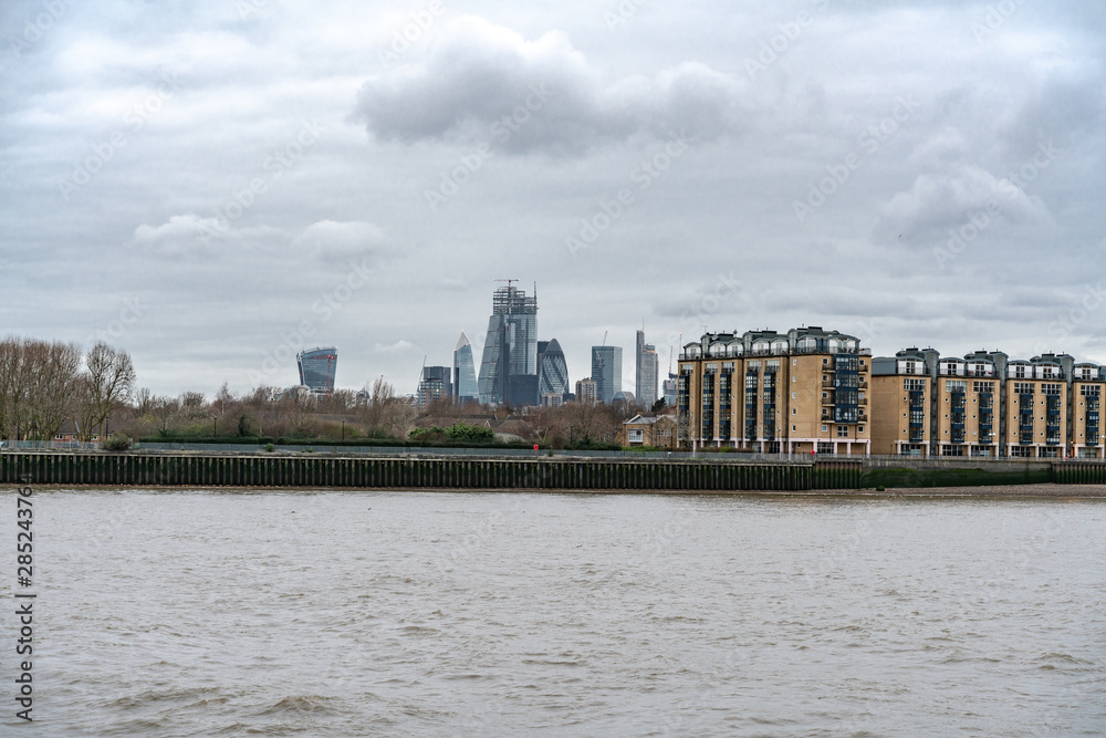 The Towers Of City of London oversee River Side Apartments, Flats and houses along the banks of The River Thames