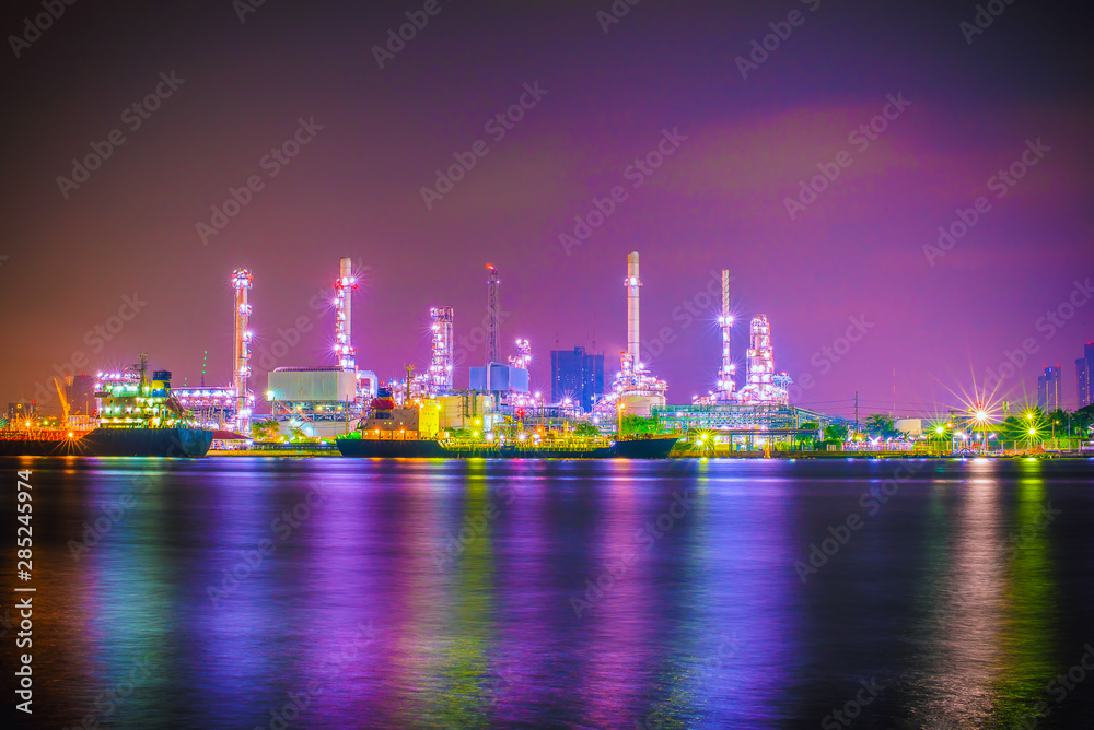 Beautiful reflection of Oil refineries located along the river with dark sky background-Image Beautiful reflection of Oil refineries located along the river with dark sky background-Image