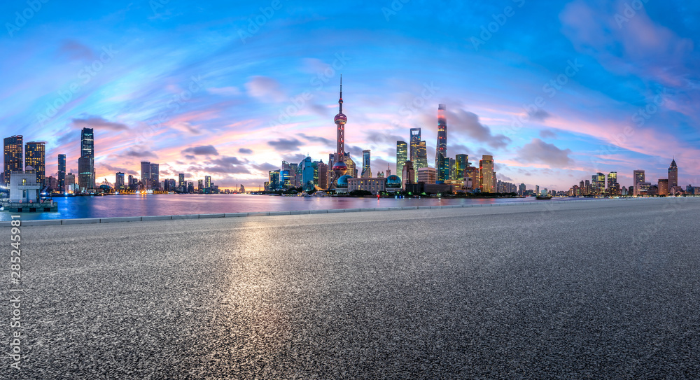 Shanghai skyline and modern buildings with empty asphalt highway at sunrise,panoramic view.