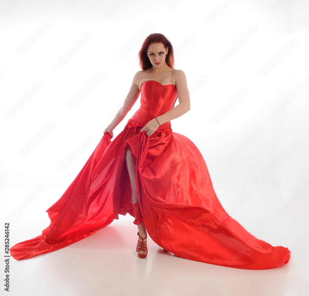 full length portrait of woman wearing red riding hook cloak and long silk gown. standing pose, isolated on white studio background full length portrait of woman wearing red riding hook cloak and long silk gown. standing pose, isolated on white studio background