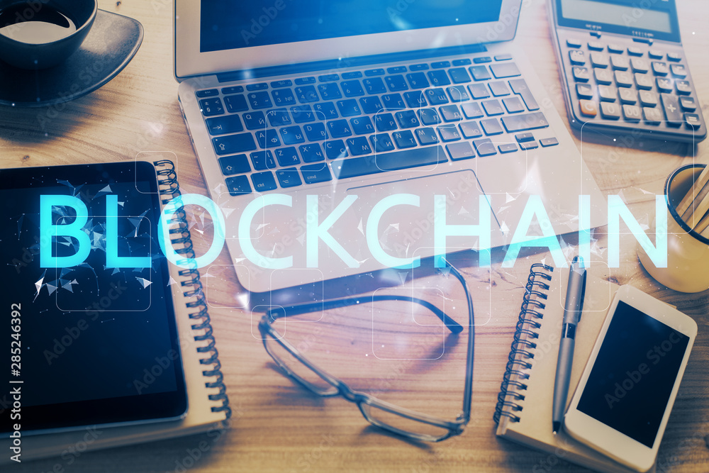 Double exposure of blockchain and crypto economy theme hologram and table with computer background. Concept of bitcoin cryptocurrency. Double exposure of blockchain and crypto economy theme hologram and table with computer background. Concept of bitcoin cryptocurrency.