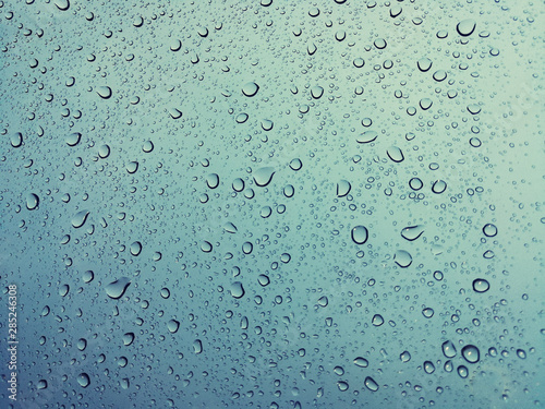 Beautiful raindrops on a window, Raindrops Or Vapor Trough on the glass, Abstract of raindrops on the mirror with a colored background. Drops of water - Image