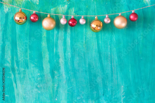 Christmas mock up with christmas balls and green painted background, free copy space