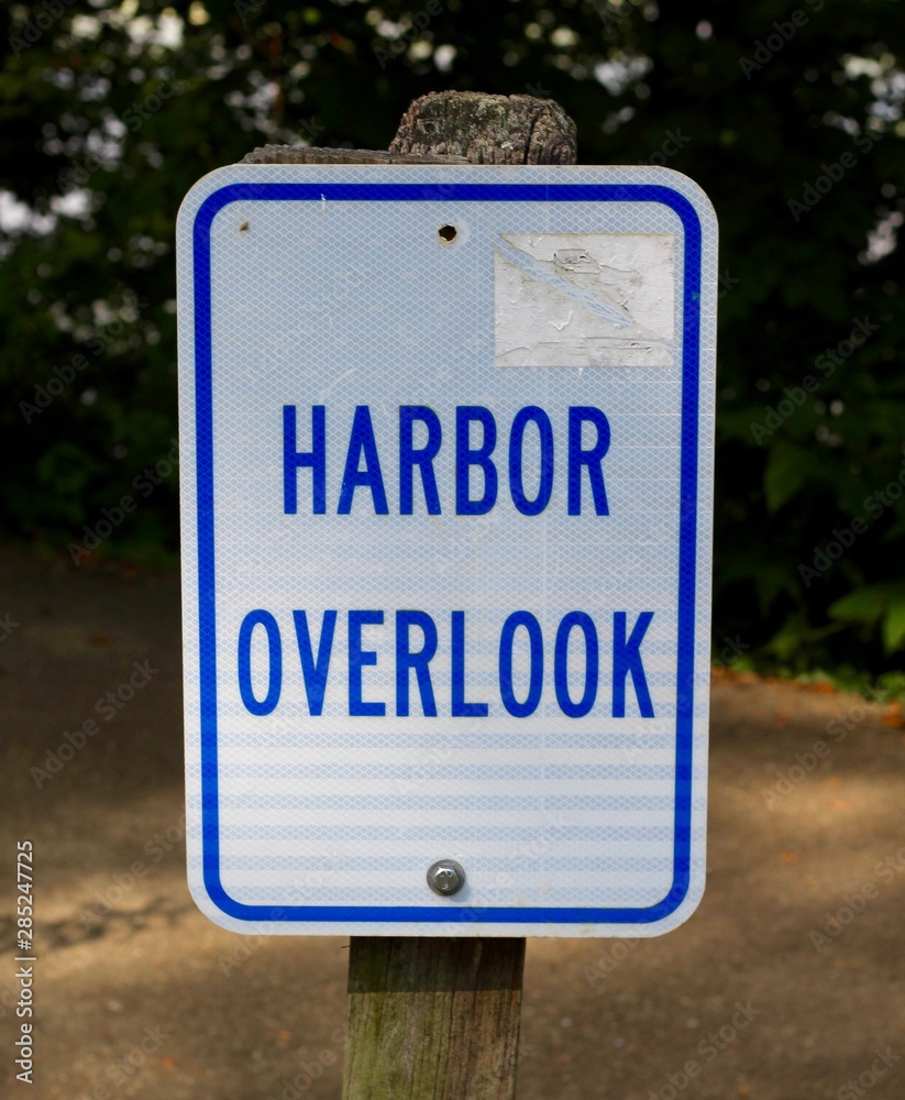 A close view of the blue and white harbor overlook sign. A close view of the blue and white harbor overlook sign.