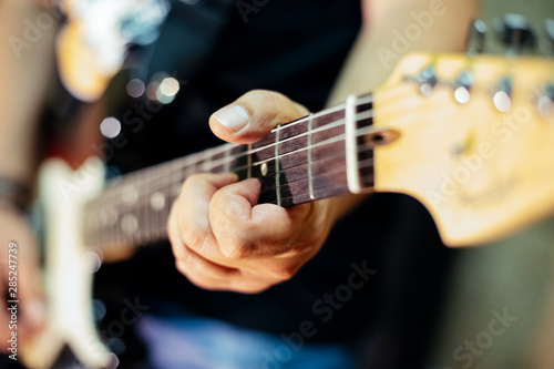 Detail of a rocker playing the electric guitar