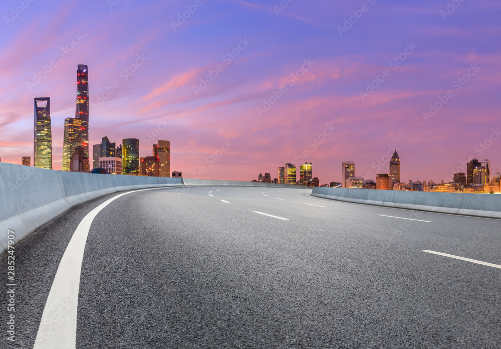 Fototapeta premium Shanghai skyline and modern buildings with empty asphalt highway at sunrise,China