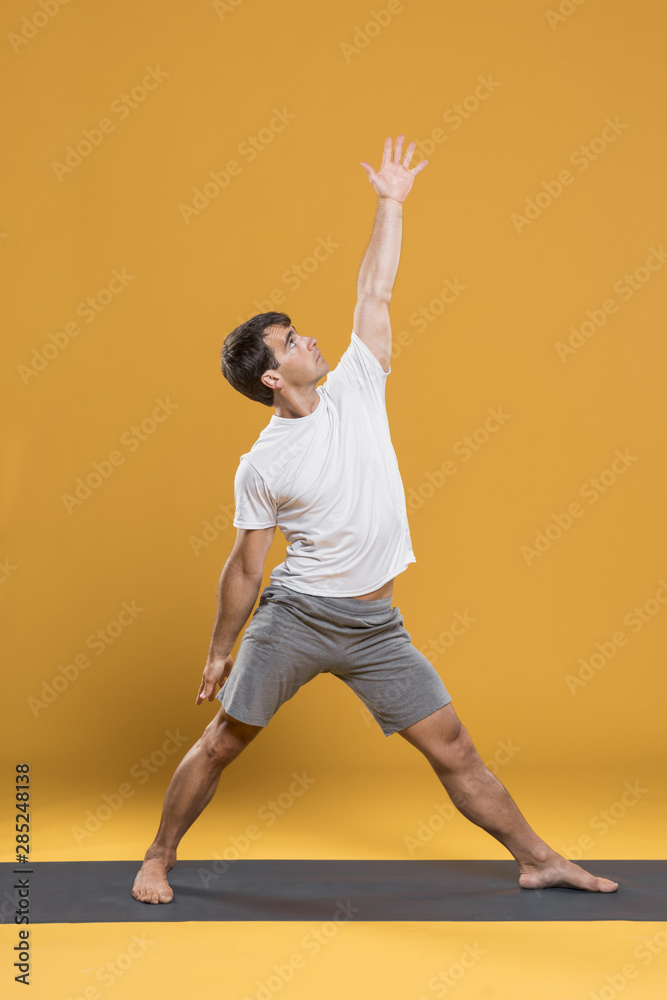Man practicing yoga on mat
