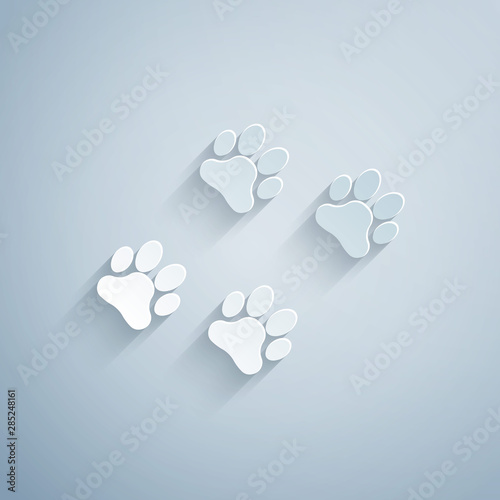 Paper cut Paw print icon isolated on grey background. Dog or cat paw print. Animal track. Paper art style. Vector Illustration