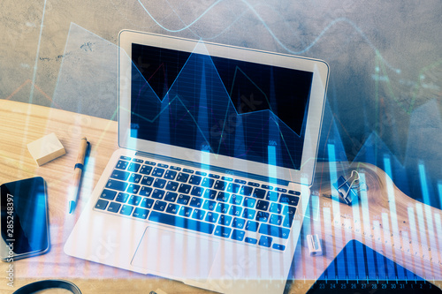 Multi exposure of chart and financial info and work space with computer background. Concept of international online trading. © peshkova