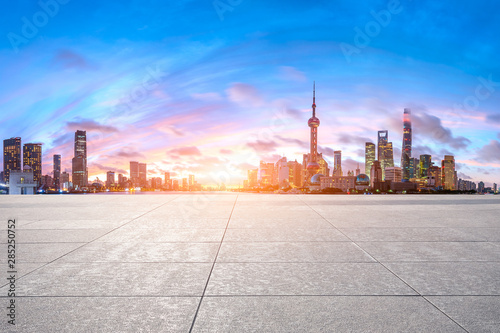 Shanghai skyline and modern buildings with empty square floor at sunrise China.