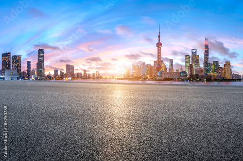 Shanghai skyline and modern buildings with empty asphalt highway at sunrise China