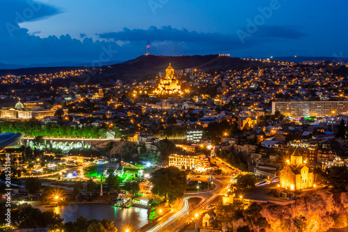 Summer night falling on Tbilisi, the capital of Georgia. Sameba cathedral, Presidential palace, Europe square and Metekhi church beautifully illuminated. photo