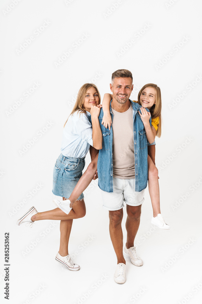 Full length photo of beautiful caucasian family woman and man with little girl smiling and posing together at camera