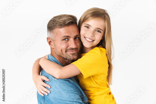 Photo closeup of beautiful caucasian family father and daughter smiling and hugging together at camera