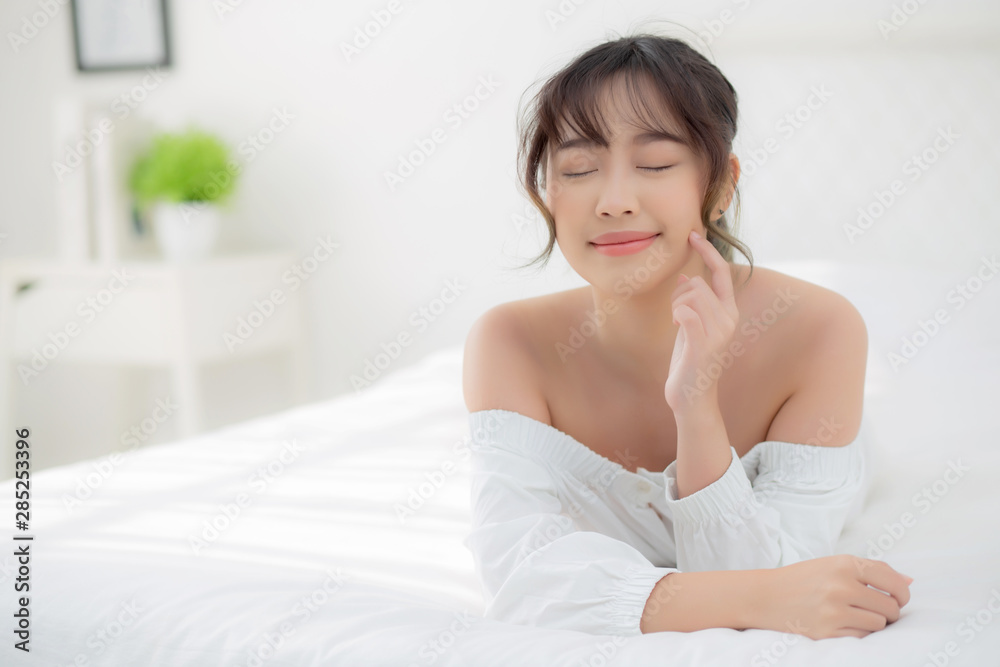 Beautiful portrait young asian woman lying and smile while wake up with sunrise at morning, beauty cute girl happy and cheerful resting on bed in the bedroom, lifestyle and relax concept. Beautiful portrait young asian woman lying and smile while wake up with sunrise at morning, beauty cute girl happy and cheerful resting on bed in the bedroom, lifestyle and relax concept.