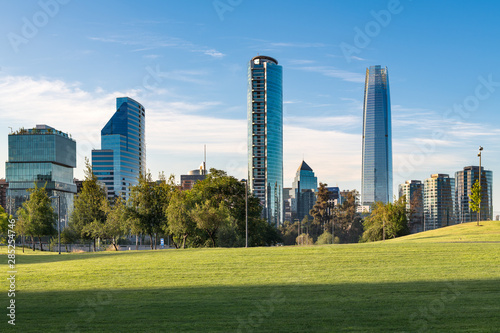 Fototapeta Naklejka Na Ścianę i Meble -  Skyline of buildings at Vitacura and Providencia districts from Parque Bicentenario, Santiago de Chile