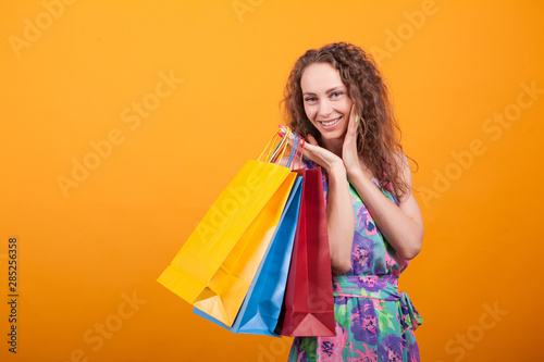 Gorgeous and shopaholic woman holding shopping bags
